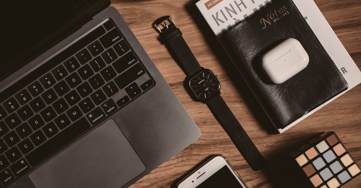 Flatlay of tech gadgets with laptop, smartphone, Rubik